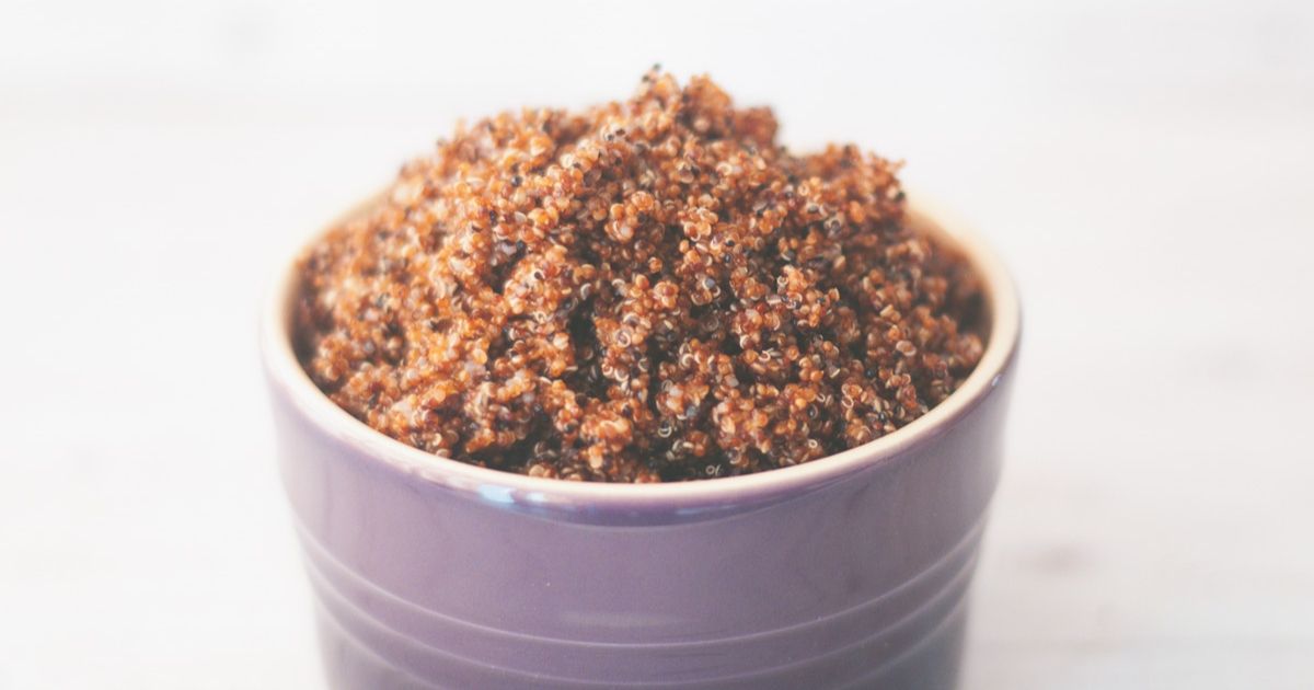 A purple bowl with cooked kaniwa