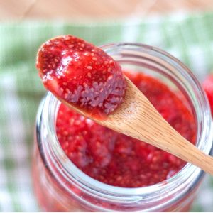 No cook strawberry chia seed jam on a wooden spoon