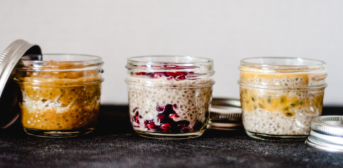 Three small jars of chia pudding with fruit