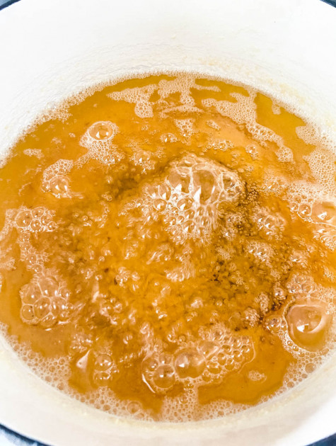 A saucepan with butter cooked down into ghee