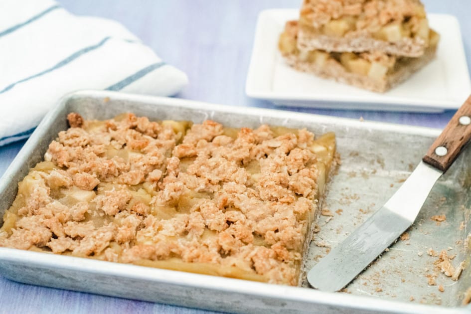 A small pan of apple butter oatmeal bars with a few pieces removed