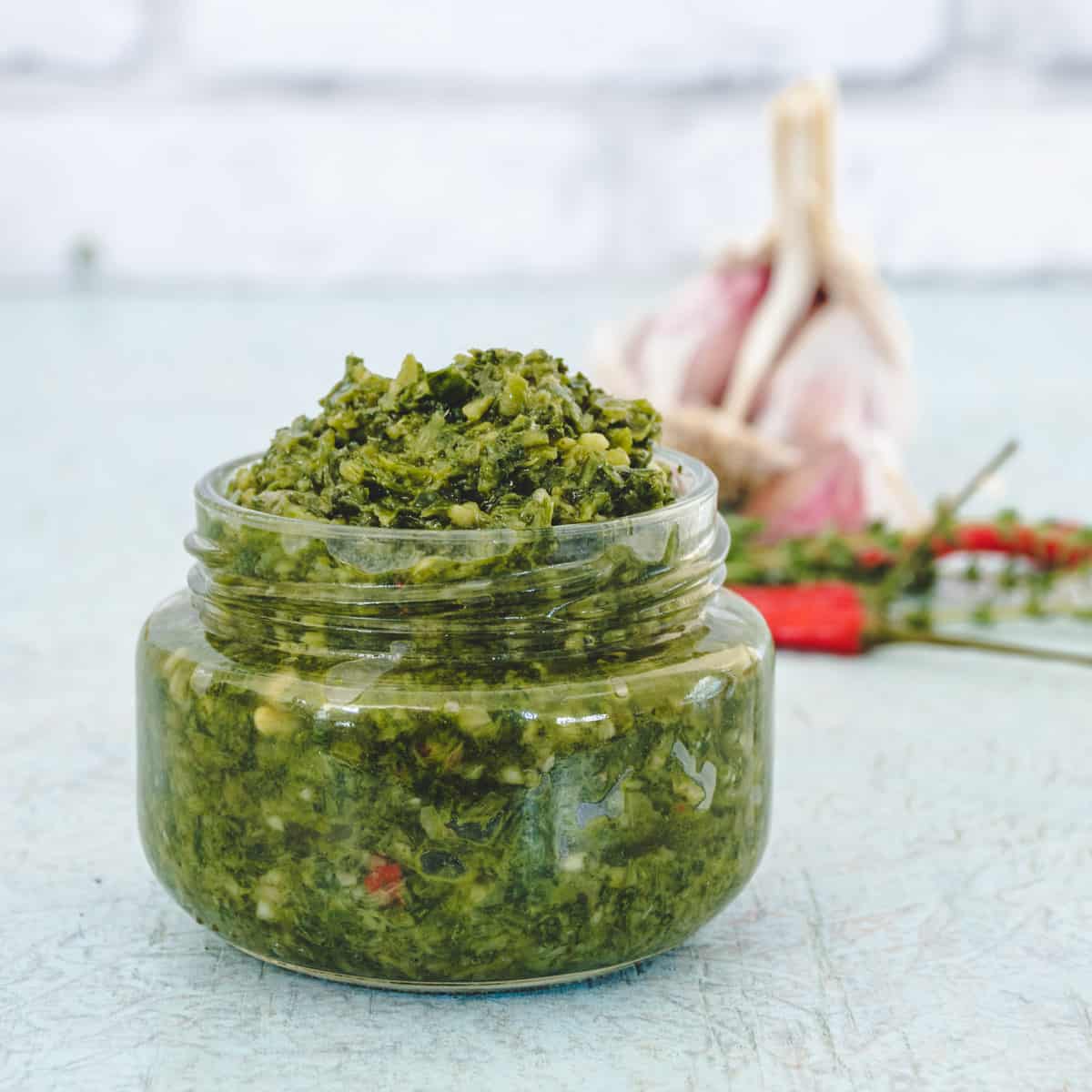 A small jar of homemade green seasoning